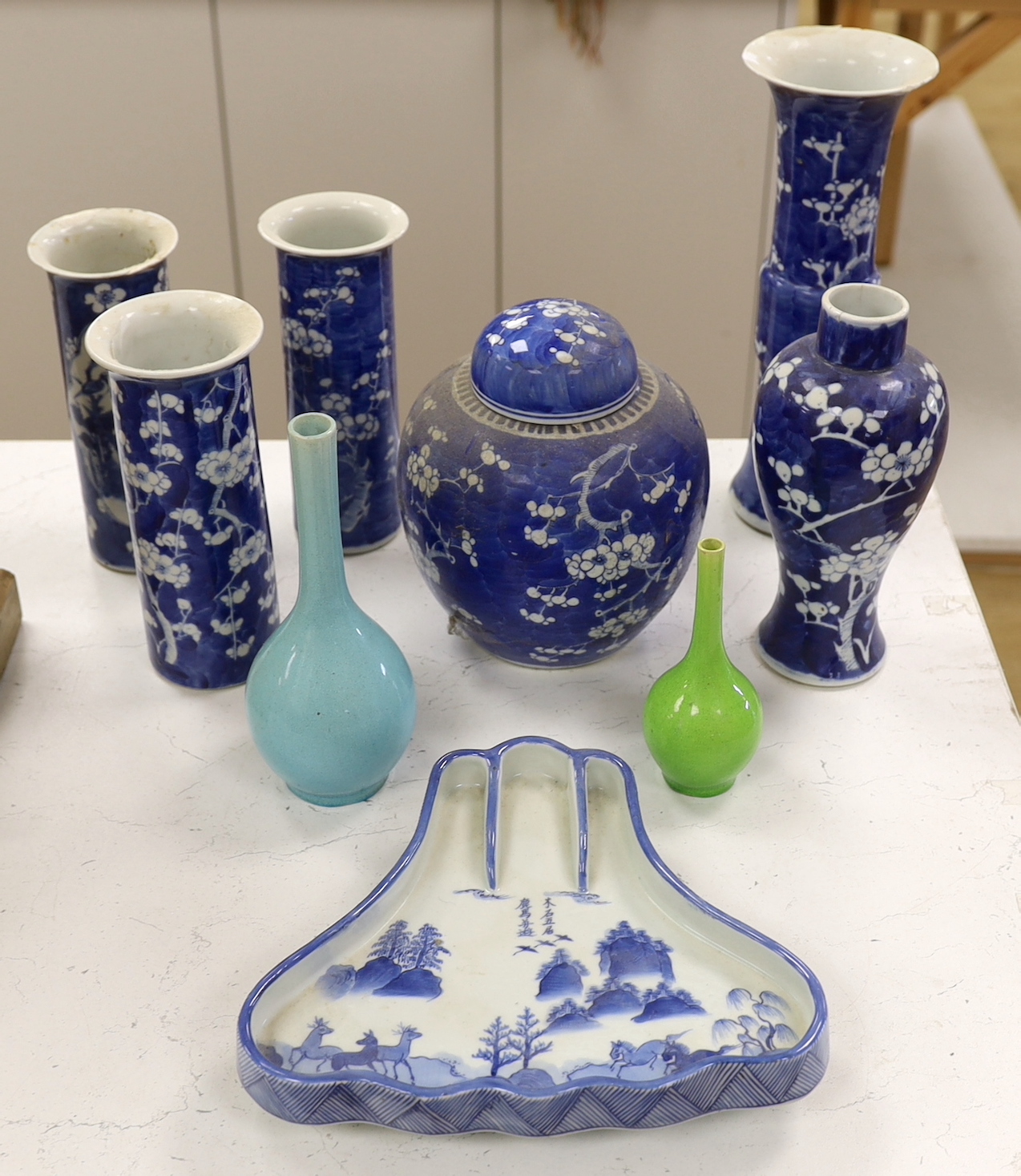 A collection of Chinese blue and white prunus vases and a jar and cover, a ko-sometsuke style dish and two bottle vases, tallest 30cm high (a.f.) (9)